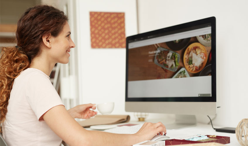 Woman looking at a website on a desktop