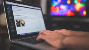 hands typing on laptop
