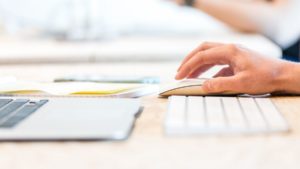 PPC specialist's hands working on a mouse and keyboard